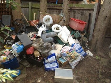 Workers managing builders waste clearance on site