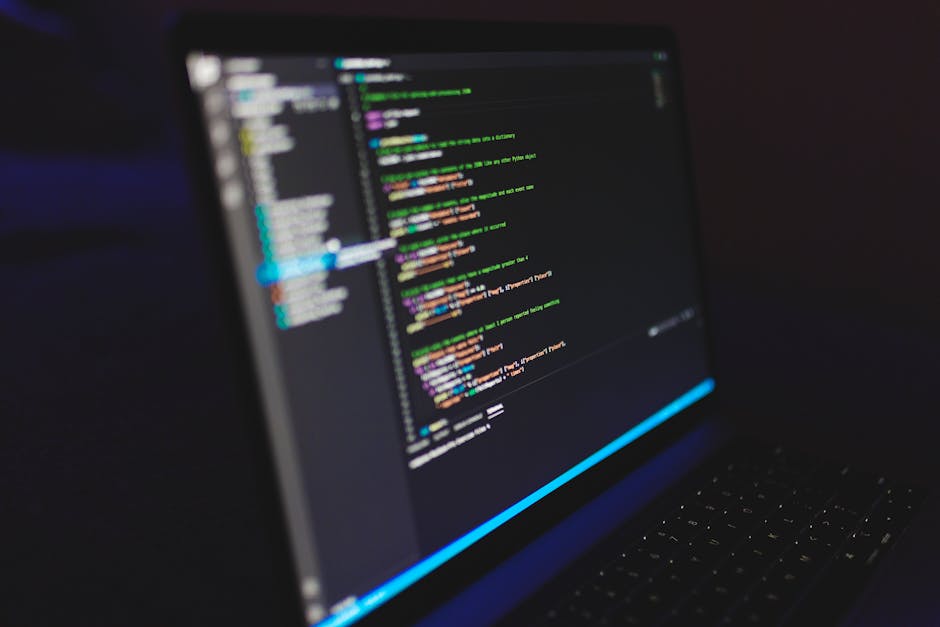 A photograph of a computer screen displaying lines of programming code with syntax highlighting in various colors including yellow, purple, green, and blue. The code appears to be related to web devel